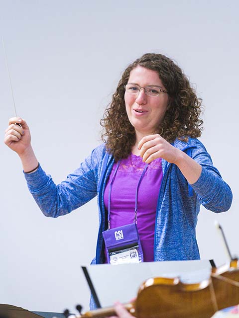 A music teacher conducting her class