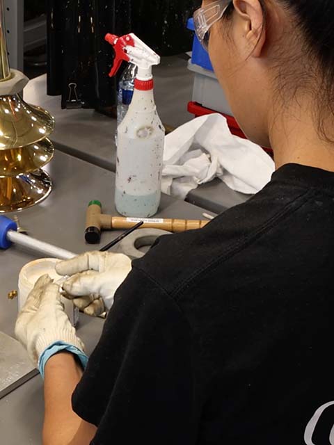 Employee working on a clarinet